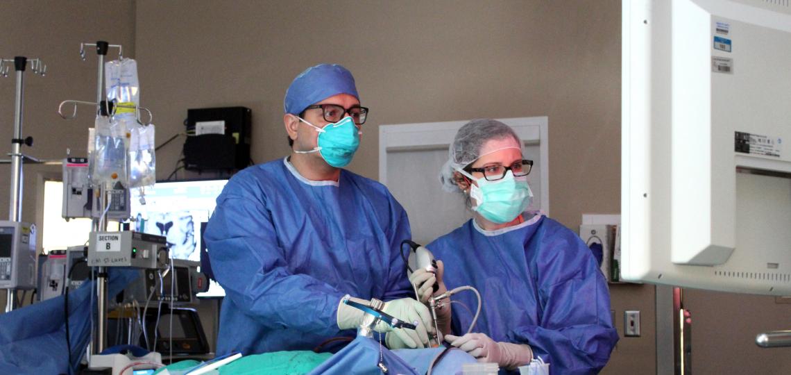 Two doctors performing a surgical procedure.