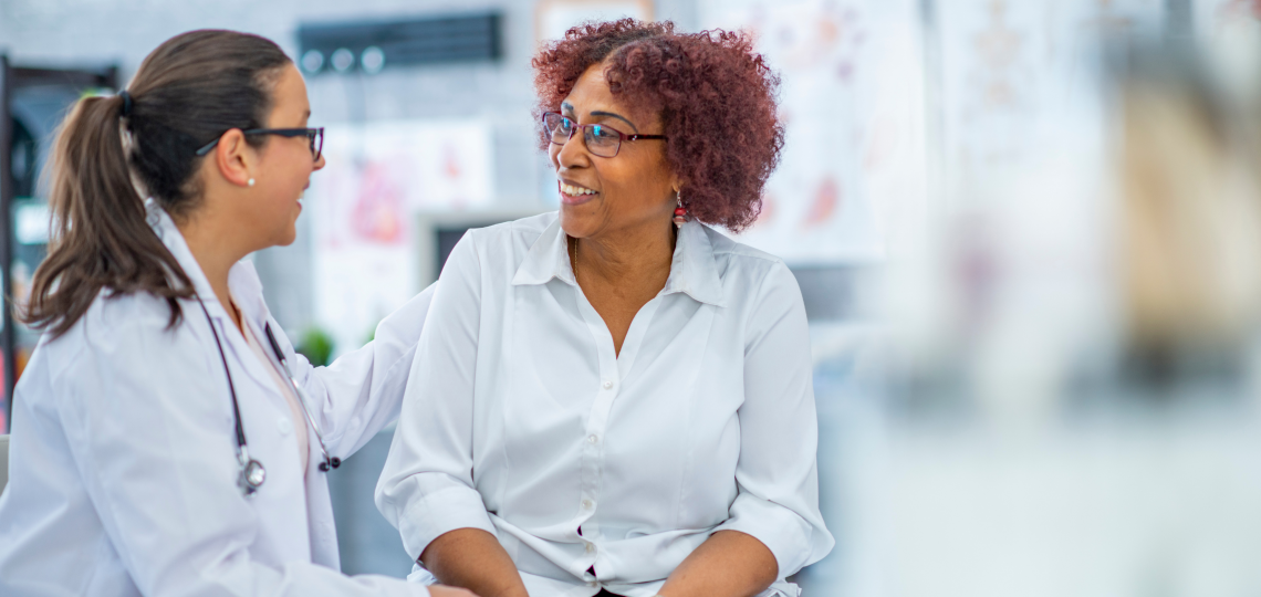 Female doctor speaking with a female patient.