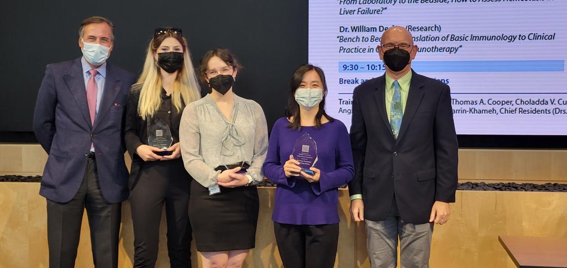 Poster presentation award winners Hanna Siatecka, Janel Peterson and Yan Chen Wongworawat receiving awards from Dr. James Versalovic and Dr. Martin Matzuk.