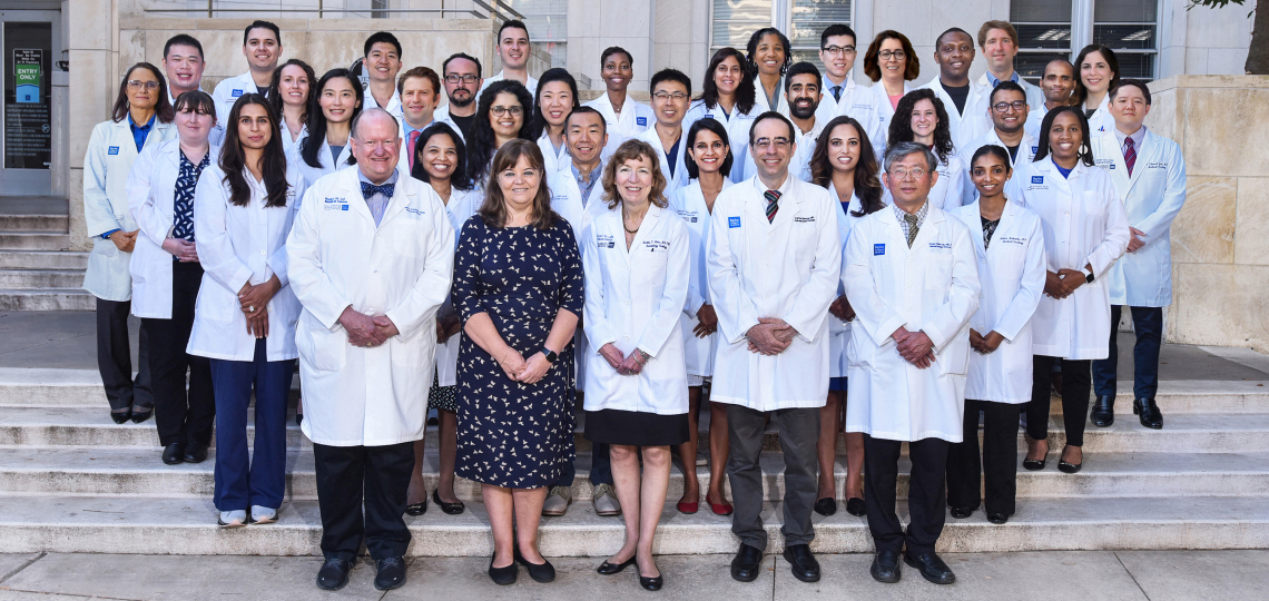 A group photo featuring the 2021-2022 Section of Hematology/Oncology. The group stands shoulder to shoulder on the steps at the front of the Main Baylor campus.