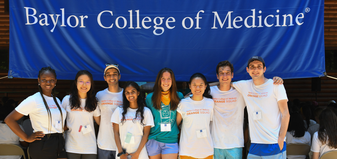 A group of students standing shoulder-to-shoulder during an orientation retreat.