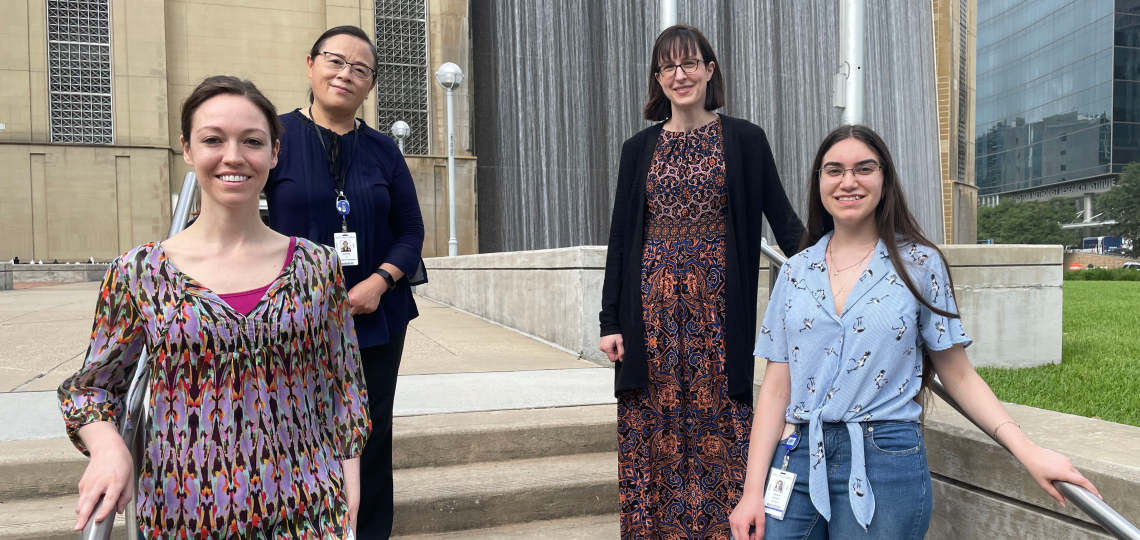 Lindsay Burrage Group Photo Members of the Lindsay Burrage lab stand outside on a set of stairs.