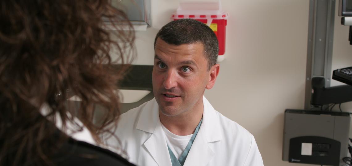 Part of Baylor Medicine's team of Gynecologic and Obstetric Specialists, Dr Todd Ivey engages with a gynecology patient. 