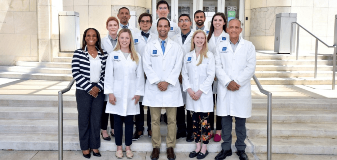 2022-2023 Infectious Diseases Fellows standing on the steps of the front entrance to Baylor