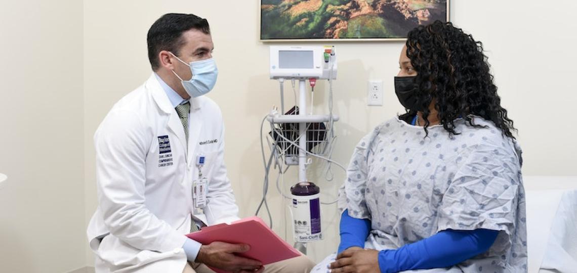 Part of Baylor Medicine's team of Gynecologic Oncology Specialists, Dr. Anthony Costales engages with a cancer patient. 