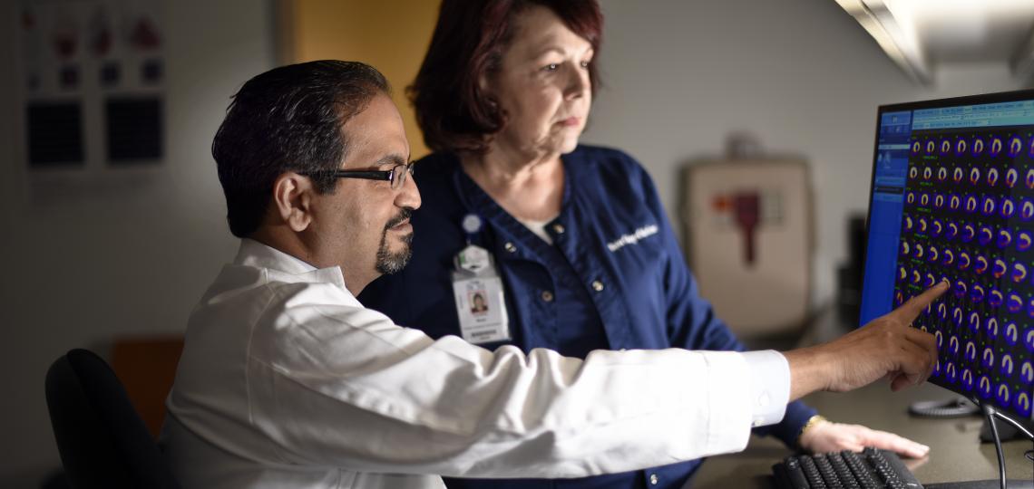 Cardiology Medical team evaluating a patient's scans on a computer screen.