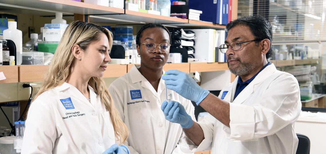 Three researchers study a sample together