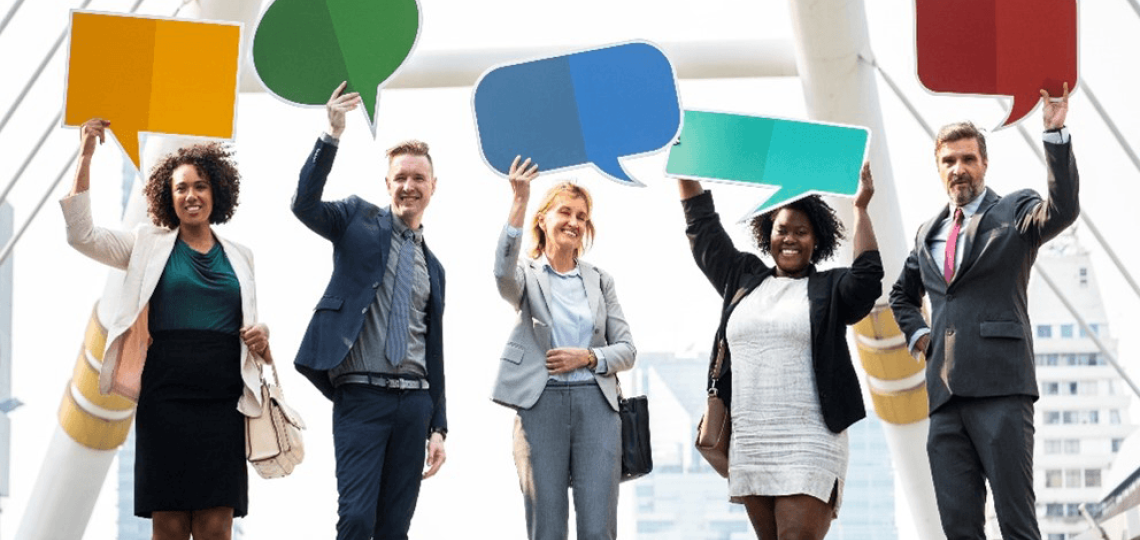 A diverse group of people holding colored comic-book-style "speech bubbles"