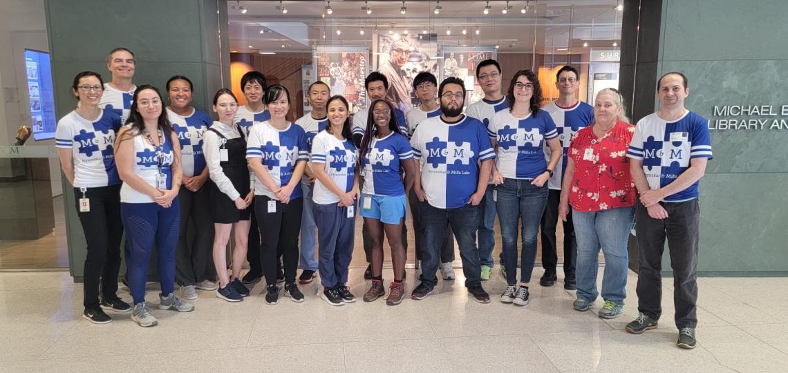 Members of the Jason Mills Lab pose in matching shirts