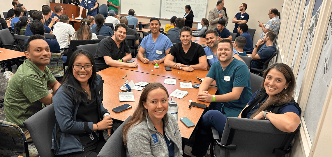 A large group seated around a table during a workshop