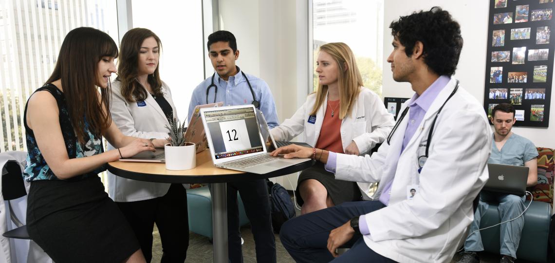 Five medical students studying together in a student lounge