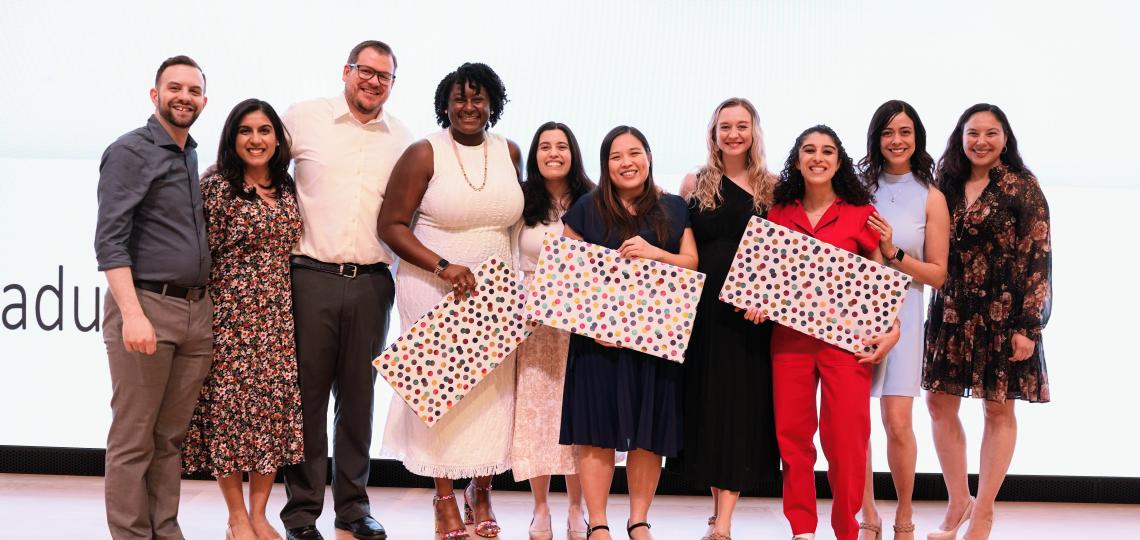 group of people holding gift wrapped boxes and smiling