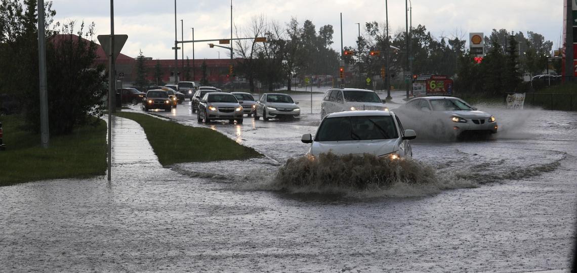 Photo of cars driving through flood water.
