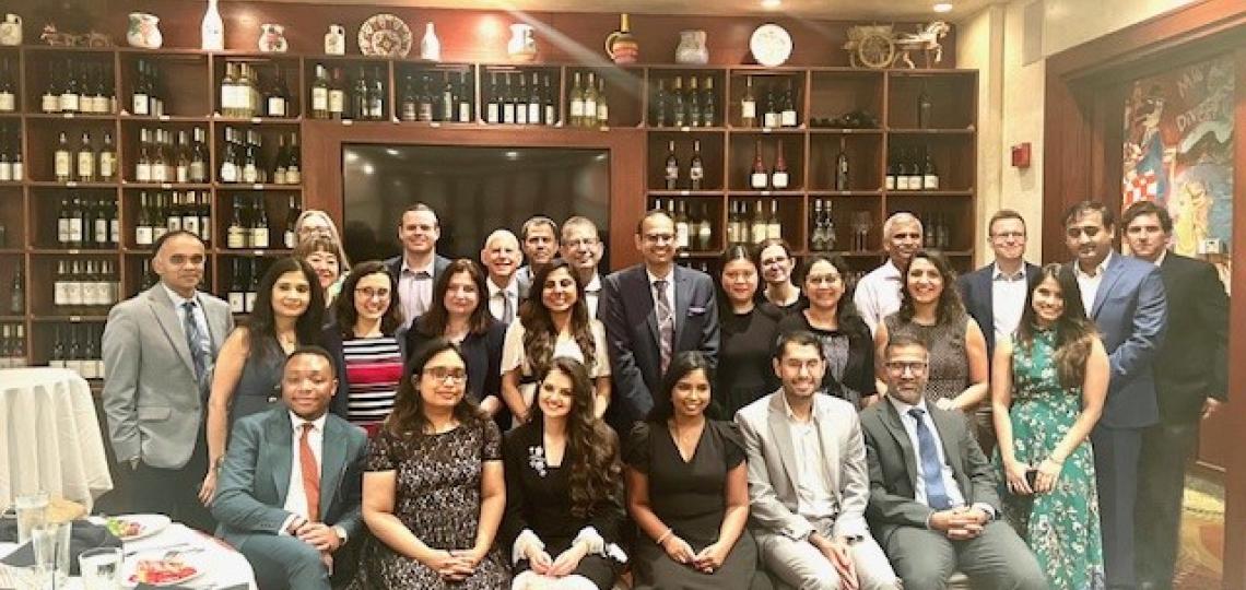 group of people smiling in restaurant 