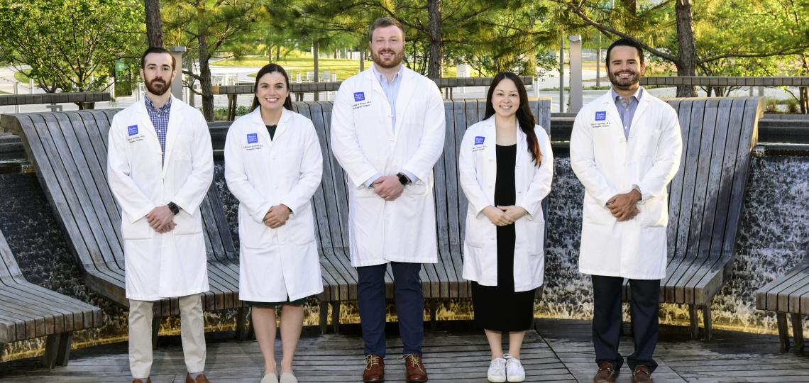 doctors standing in a line outside smiling