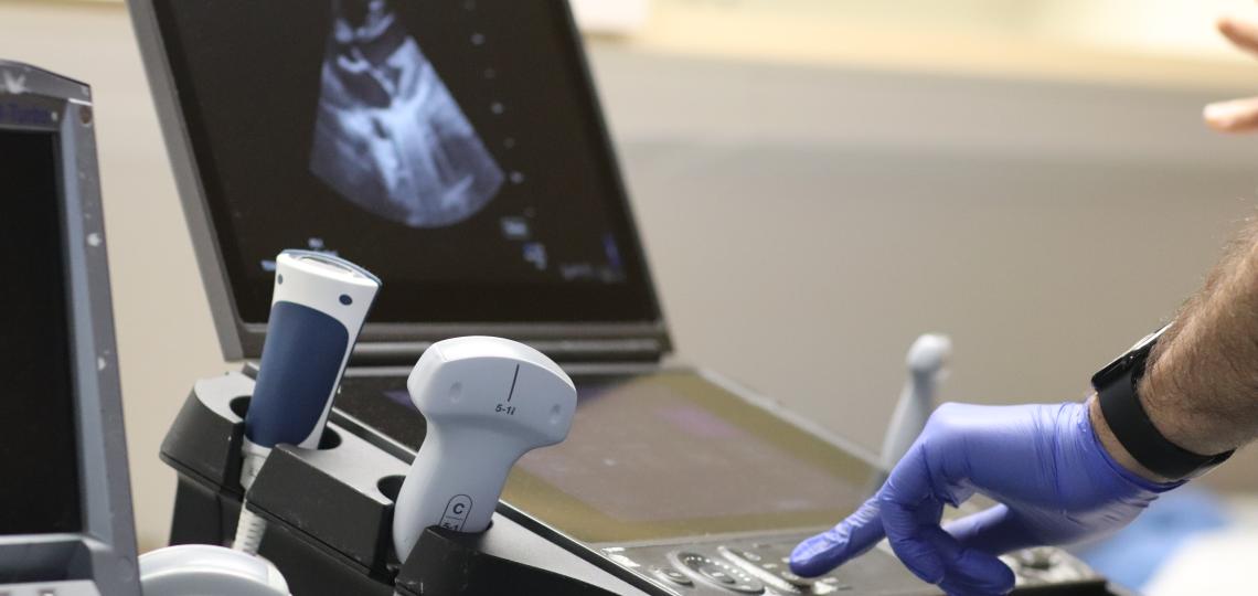 hands controlling an ultrasound computer