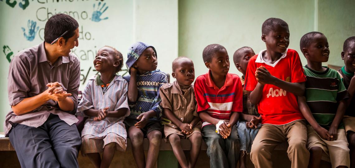 children sitting and laughing with an adult