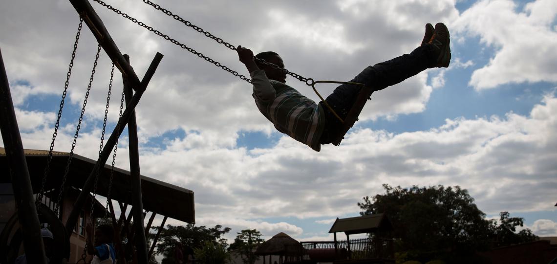 child swinging on a swing