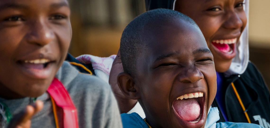 3 children smiling in laughter