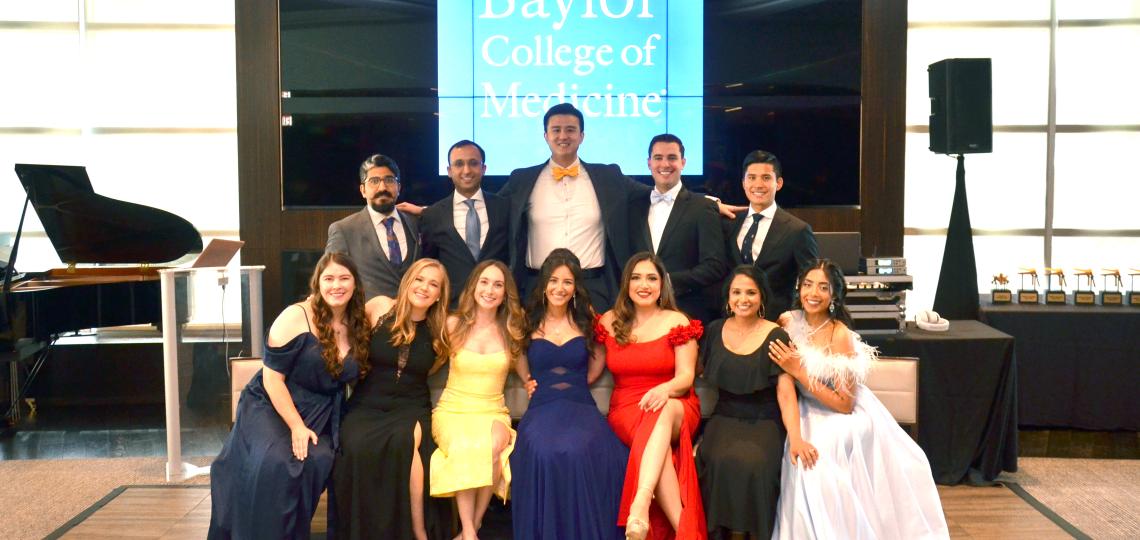 ob/gyn residents dressed in formal attire smiling