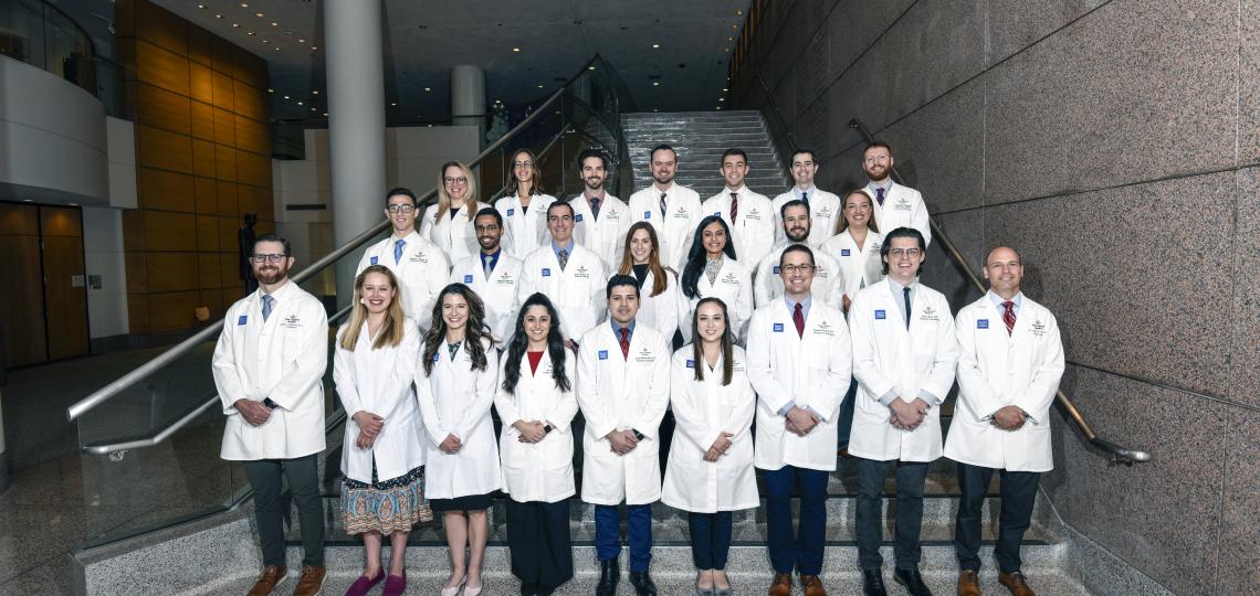 group of doctors smiling on a staircase