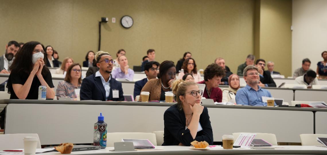 people sitting in the audience at a seminar