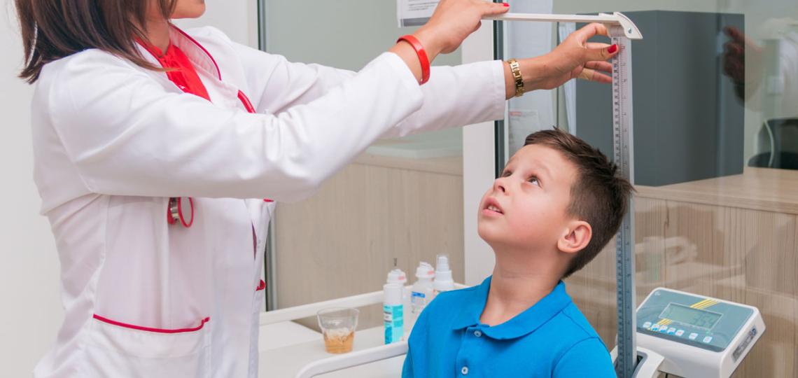 Young boy being measured Young boy being measured