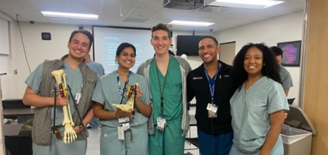 Orthopedic residents posing with learning tools