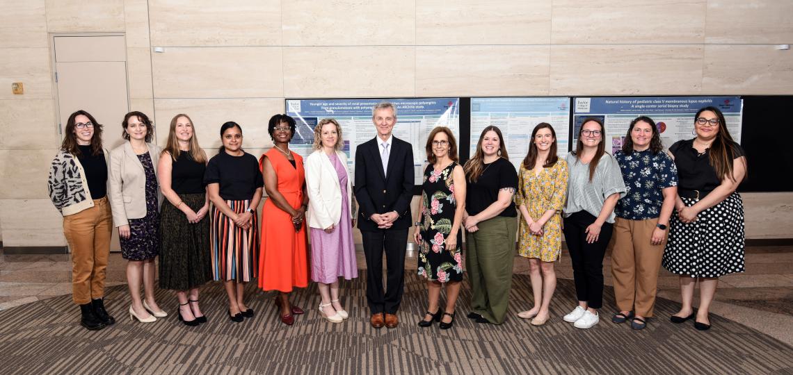 group of people standing in a line, smiling