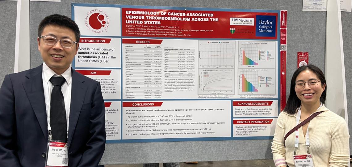 two people smiling by their scientific poster board