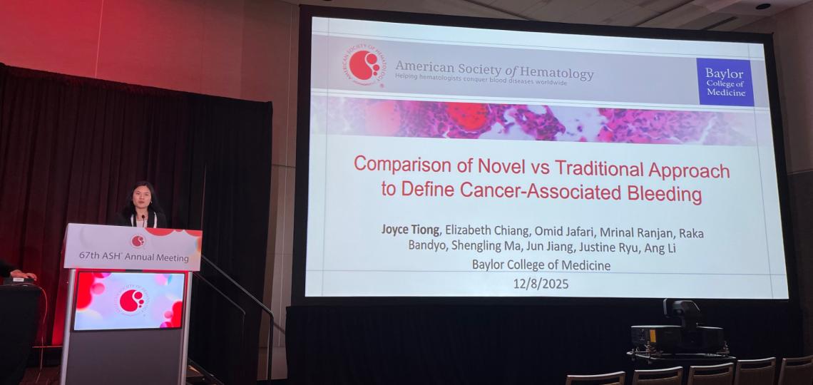 person standing at a podium, presenting on cancer-associated bleeding