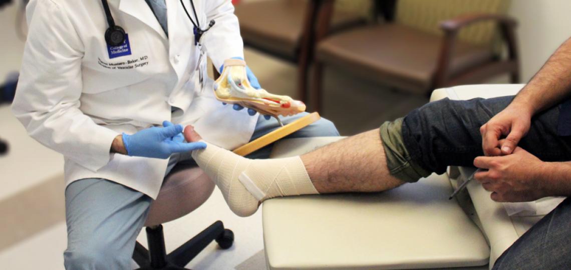 Dr. Miguel Montero-Baker assesses a patient's leg.