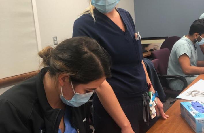 Trainees inspect a simulation model.
