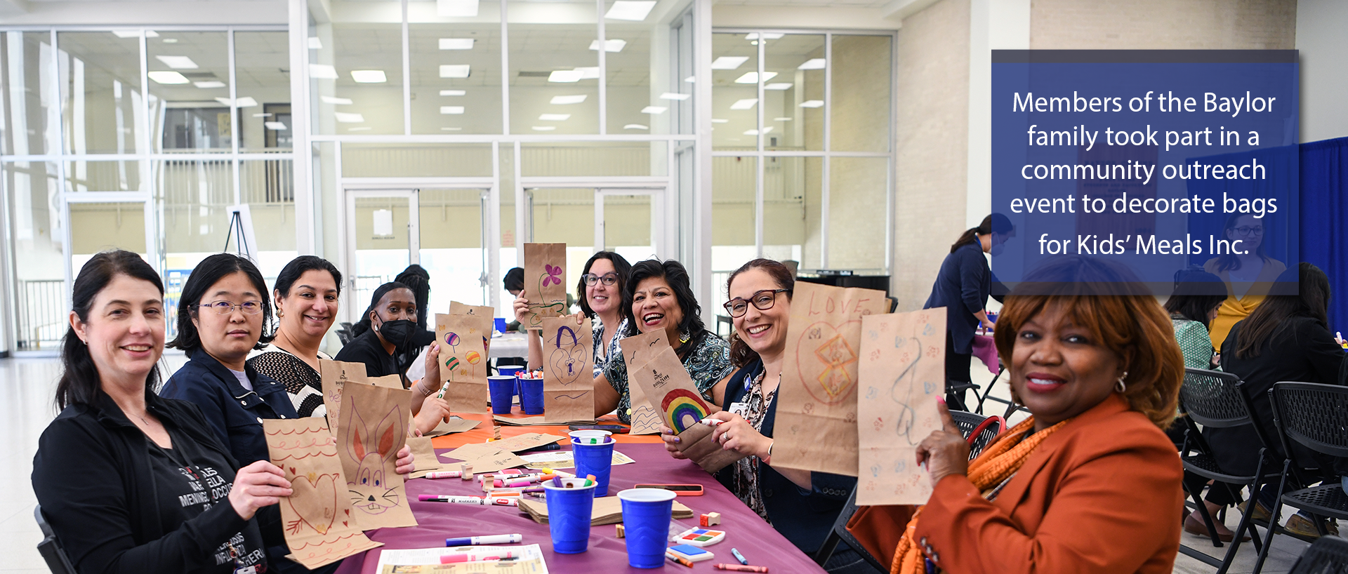 Members of the Baylor family took part in a community outreach event to decorate bags for Kids' Meals Inc. 