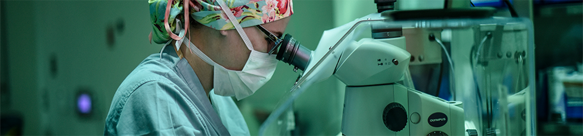 doctor looking through a microscope