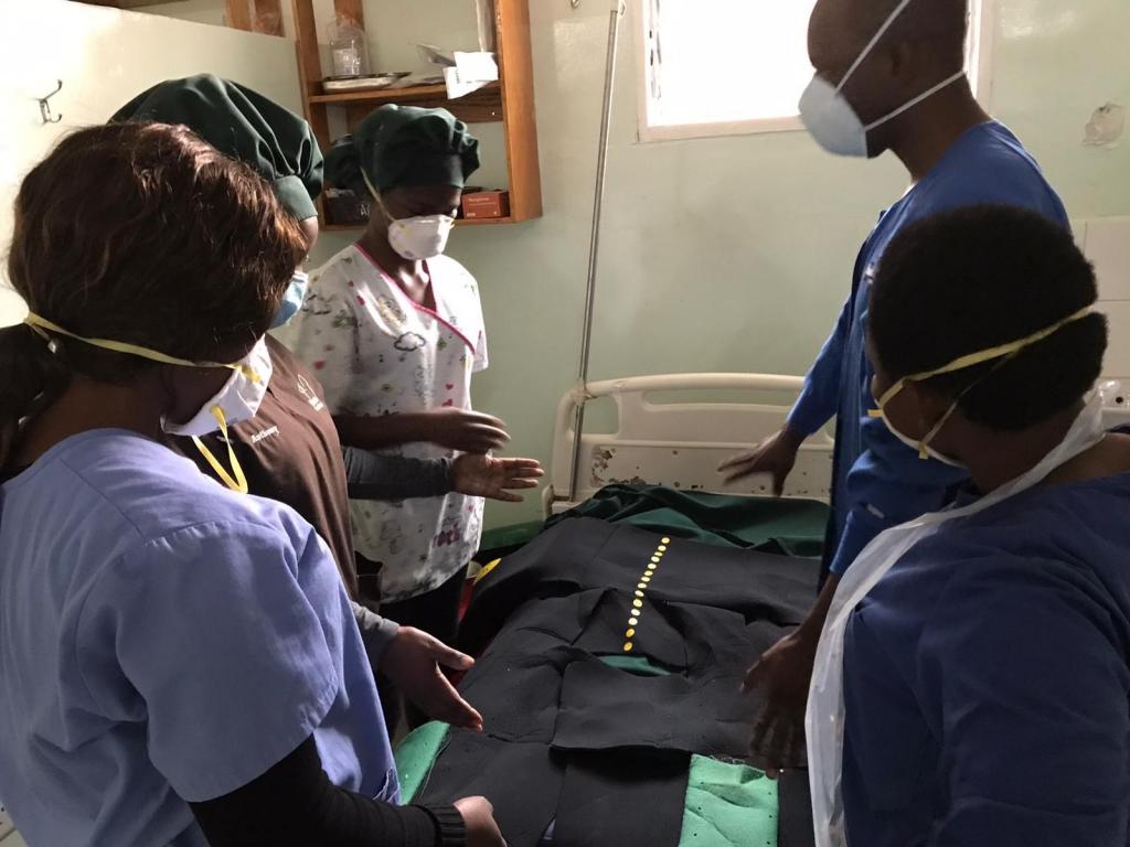 Global Women's Health Track residents attending a patient in the Malawi clinic.