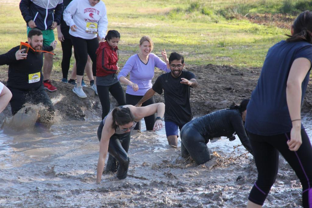 The O’Connor team getting muddy as they run, walk, crawl, slip and slide across this filthy three-mile obstacle course. Go team!