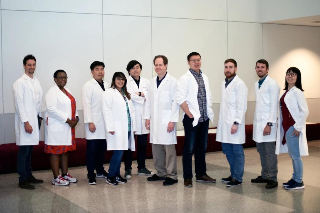 Research team suited up in lab coats.