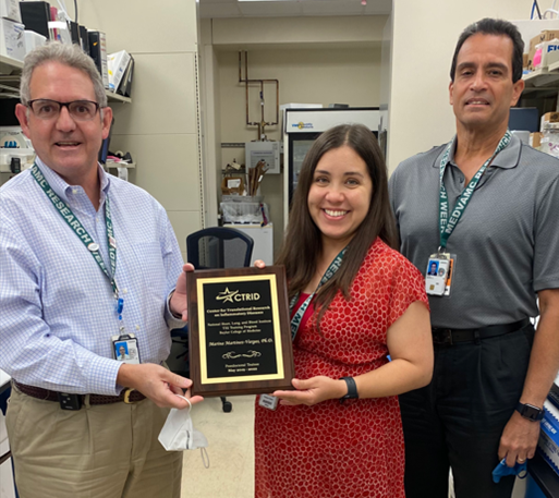 Former CTRID T32 Trainee, Dr. Marina Martinez-Vargas, receiving her graduation award from CTRID Director Dr. Rolando Rumbaut and CTRID Co-Director Dr. Miguel Cruz.