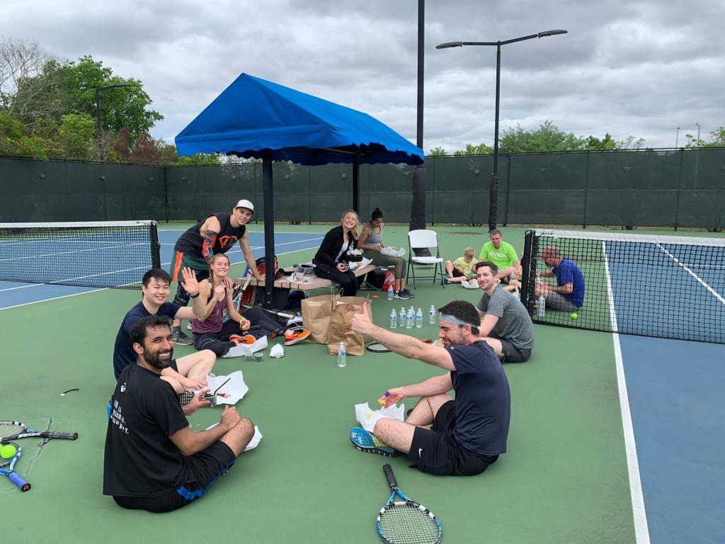 Residents snacking on a tennis court