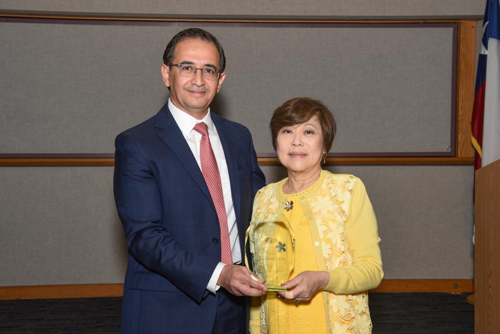Dr. Hashem El-Serag (left) giving Dr. Nancy Chang (right) an award honoring her impact on the Department of Medicine at Baylor College of Medicine (2023)