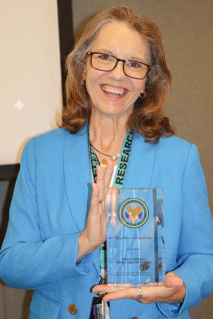 Paula Kinsel, former Director of Research Operations at MEDVAMC, presented with the Excellence in Leadership Award at her retirement party held on May 22, 2024