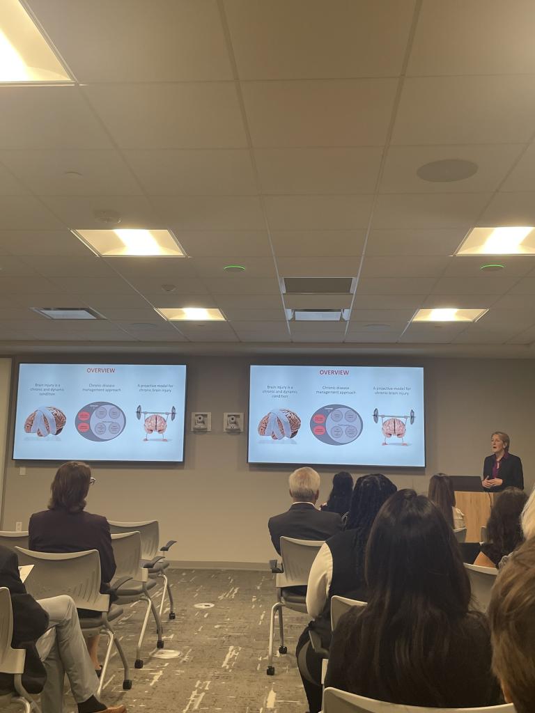 person giving presentation with two tvs beside them