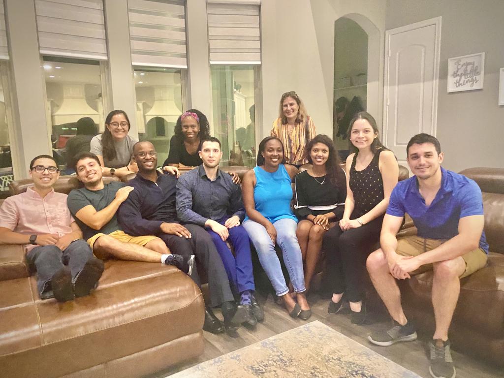 group of people sitting on couches smiling