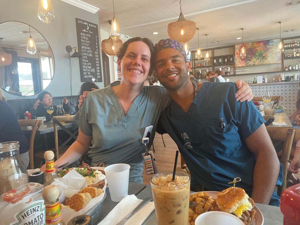 two people smiling at breakfast