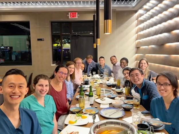 group of people smiling at a dinner event