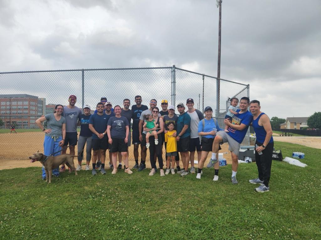 people smiling at a baseball field