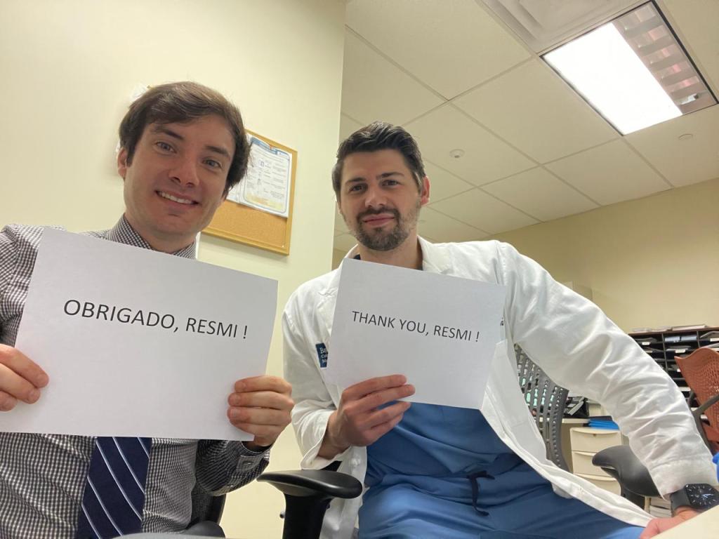 two residents holding thank you signs