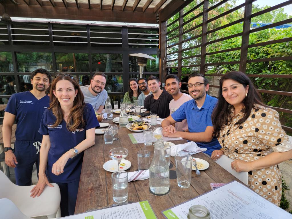 group of people smiling at dinner