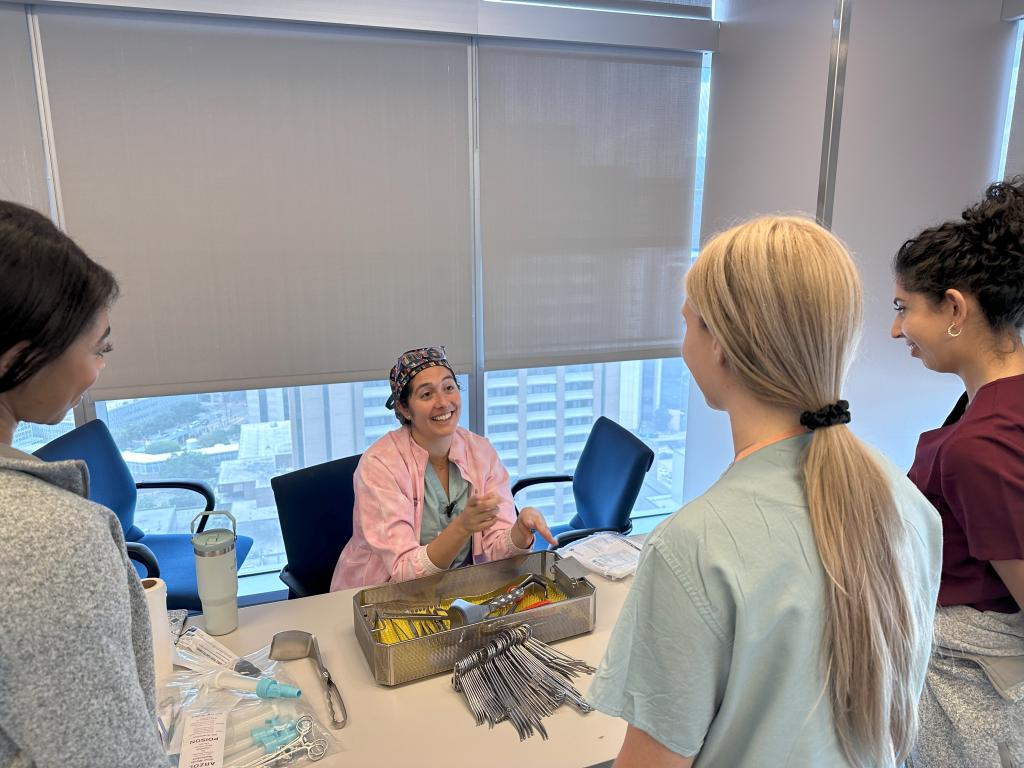 OB/GYN residents looking at tools